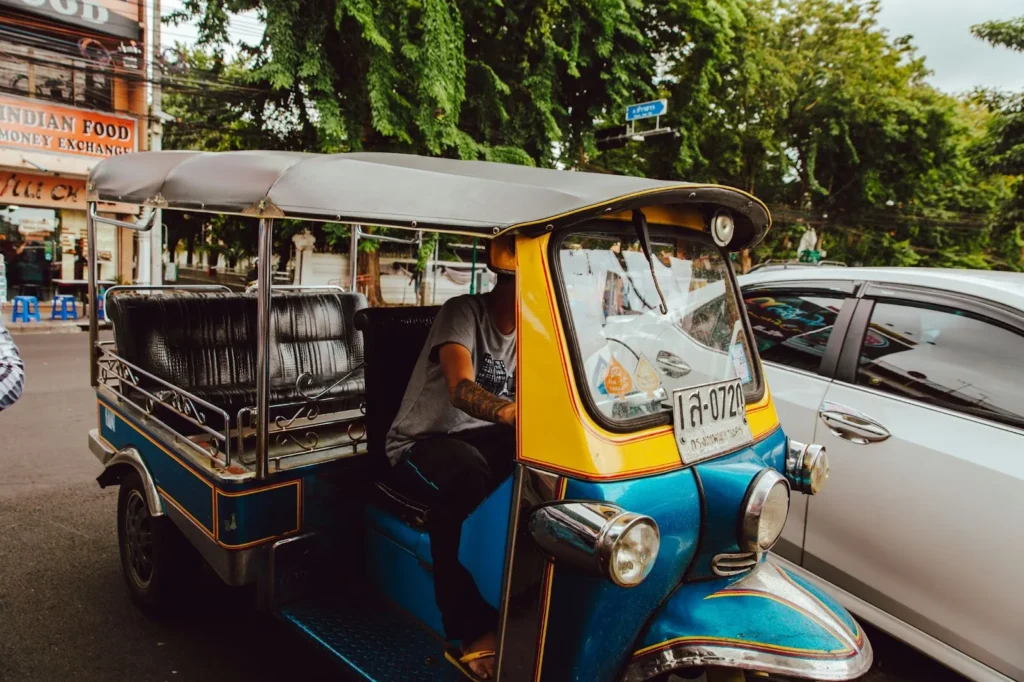 A blue and yellow-painted tuk-tuk in Bangkok